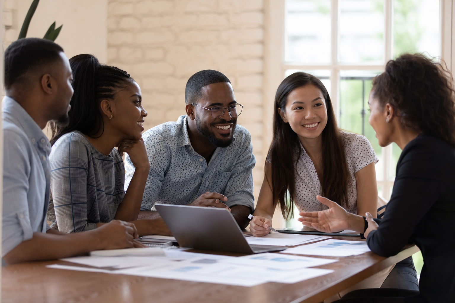 An advisory team working through client files around a table